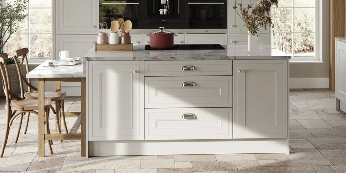Kitchen island with light grey panel doors and cup handles